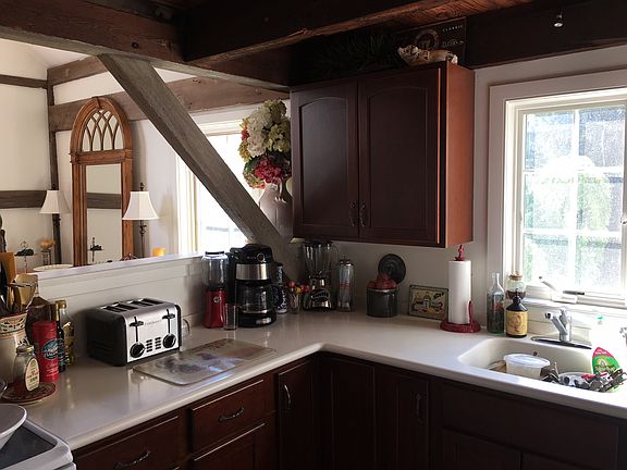 Kitchen; view into dining room. Custom Kraftmaid cherry cabinetry, Corian countertops.