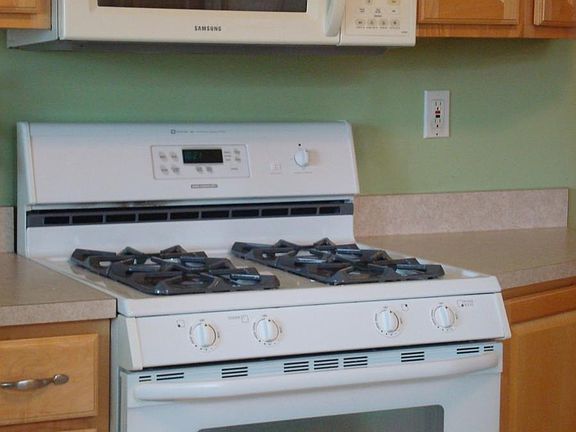Kitchen with built in microwave and gas stove 