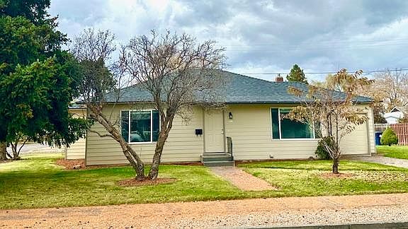 Front of house shows mature trees on this 1/4 acre lot & single attached garage. There is plenty of street parking as well. There are large windows throughout providing an abundance of light! Blinds throughout home.