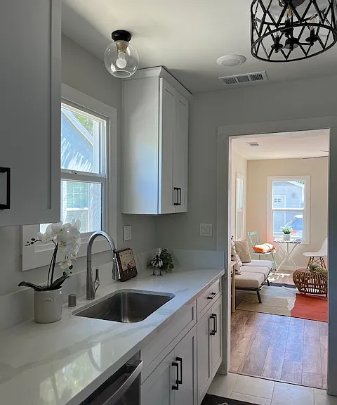 Beautiful and bright kitchen with brand new everything! Stainless steel appliances including gas stove, dishwasher, refrigerator, microwave hood. White shaker cabinetry and white quartz counter top and backsplash, white tile flooring, LED lighting.