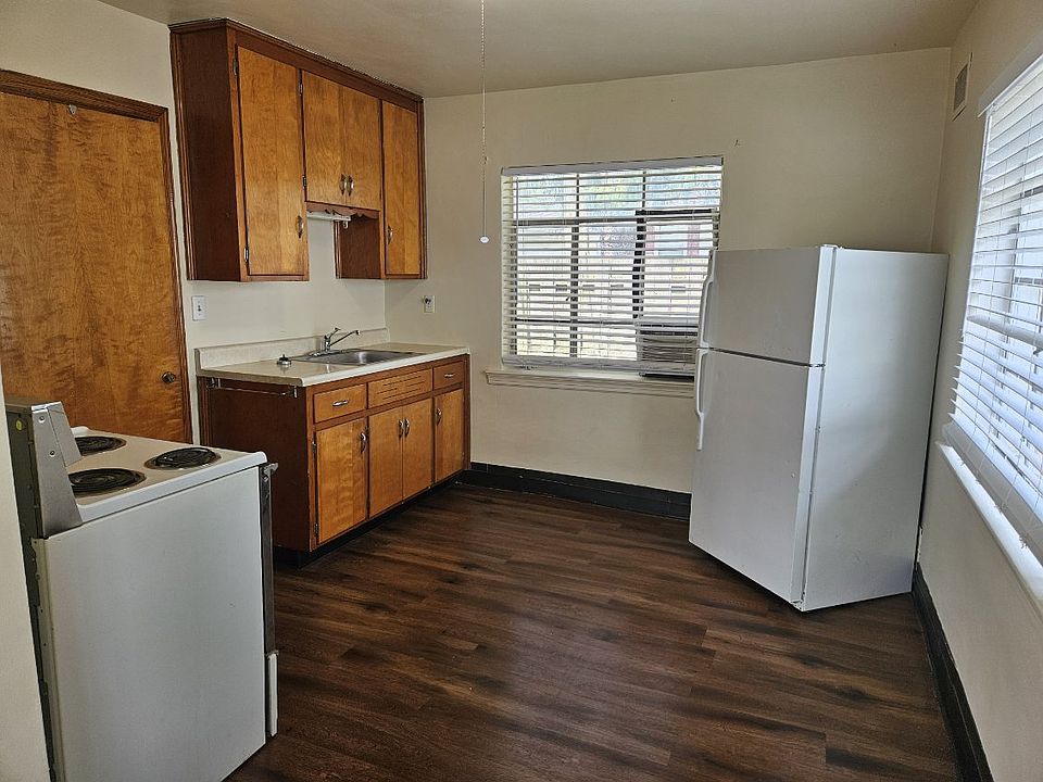 Spacious kitchen with window AC. Door to left is the laundry/mud room. Back door off of this room.