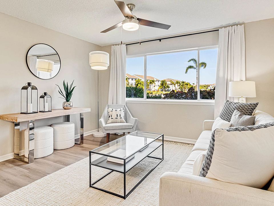 Bright living spaces with large windows and cheerful ceiling fans for an uplifting vibe.