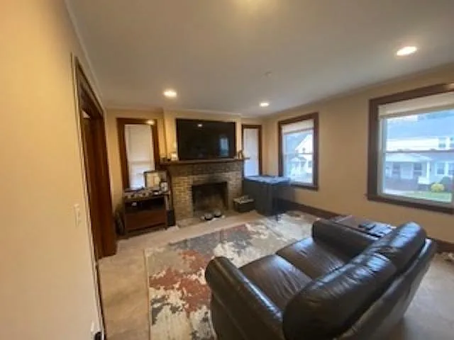 Living Room with fireplace and front door