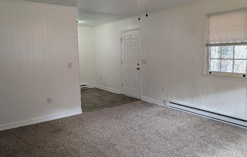 FRONT ENTRANCE INTO LARGE LIVING ROOM. STORAGE CLOSET TO THE LEFT WITH LIGHTED CEILING FAN