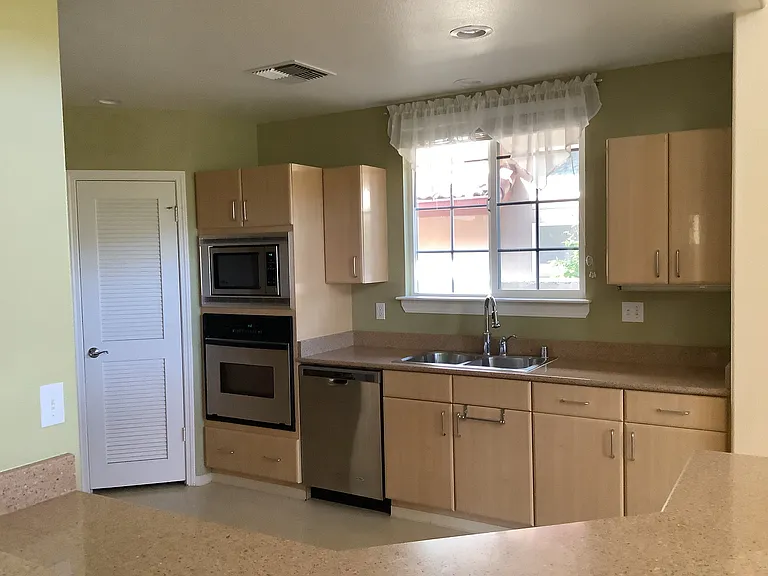 Kitchen (microwave, oven, dishwasher, pantry) from breakfast bar/island