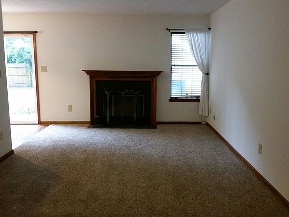 Living room with wood burning fireplace.