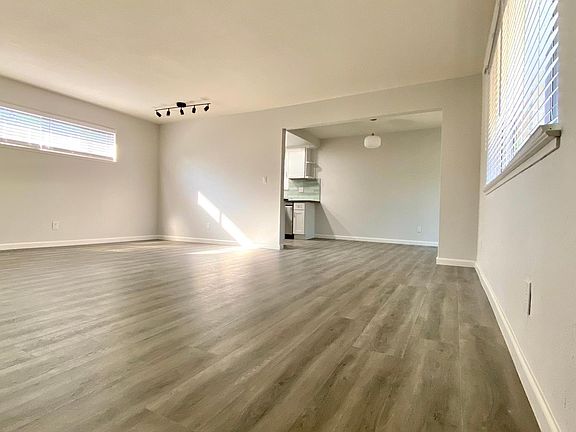 Living Room from front door facing towards dining area and kitchen. Notice the beautiful new hardwood flooring throughout the entire apartment.