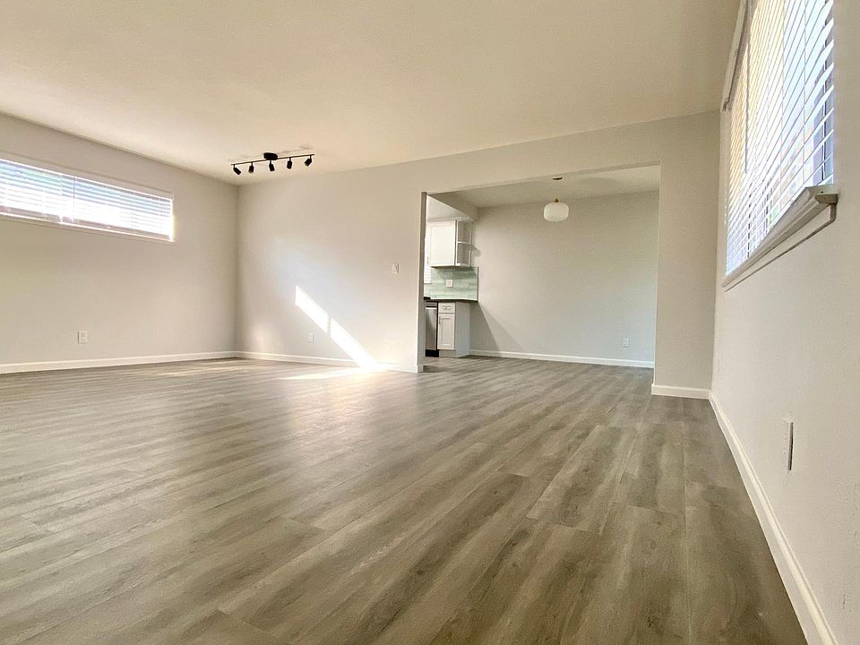 Living Room from front door facing towards dining area and kitchen. Notice the beautiful new hardwood flooring throughout the entire apartment.