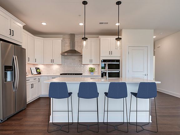 Spacious Kitchen with Stainless Steel Appliances and Oversized Island