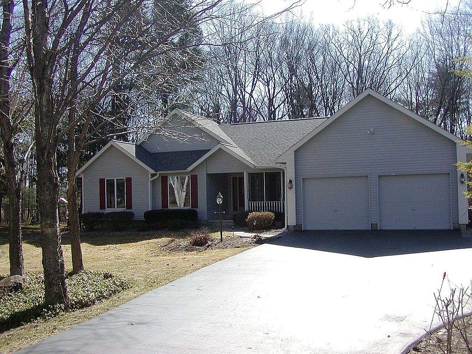 Front entrance is graced by mature birch trees