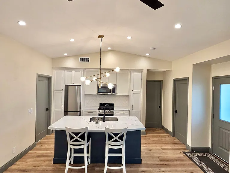 Beautiful design: LVP flooring, custom cabinetry, quartz countertop and painted trim.