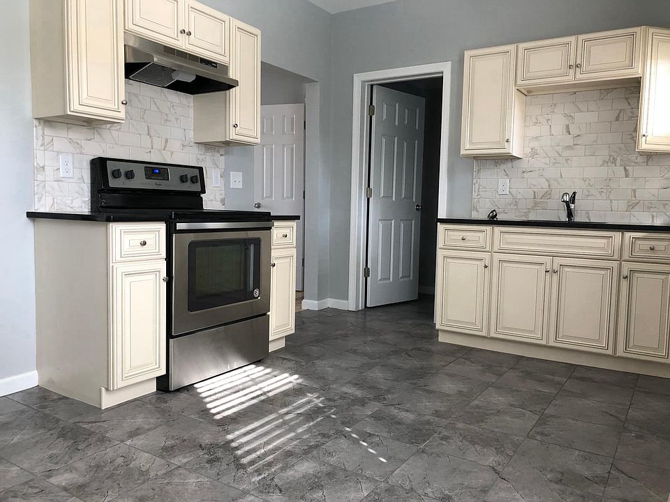 Designer kitchen with stainless appliances, marble backsplas