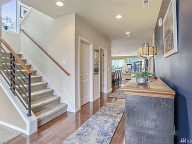 This gorgeous entry is bright and inviting! You'll love the modern railing, accent wall and gleaming floors that draw you into this spacious home. A deep entry closet provides extra storage.