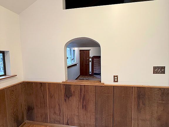 Sleeping loft creekside viewing window (above) and arched passageway to the Living room from Dining room