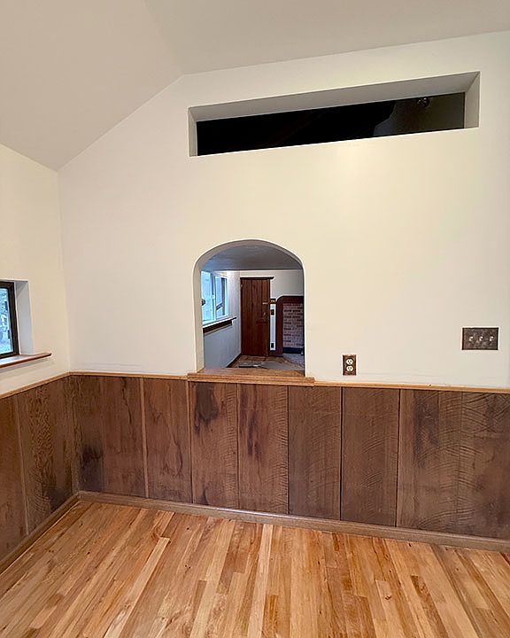 Sleeping loft creekside viewing window (above) and arched passageway to the Living room from Dining room