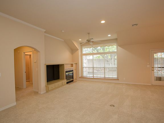 Family room with built in bookcases and higher ceilings