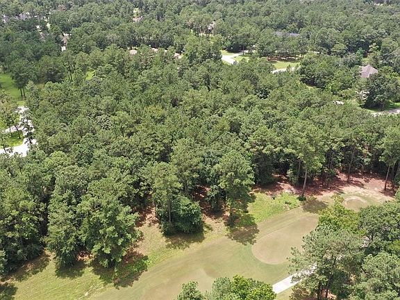 Heavily wooded lot. Clear as much as you like and still have tons of shade and privacy while living on the Glf course!