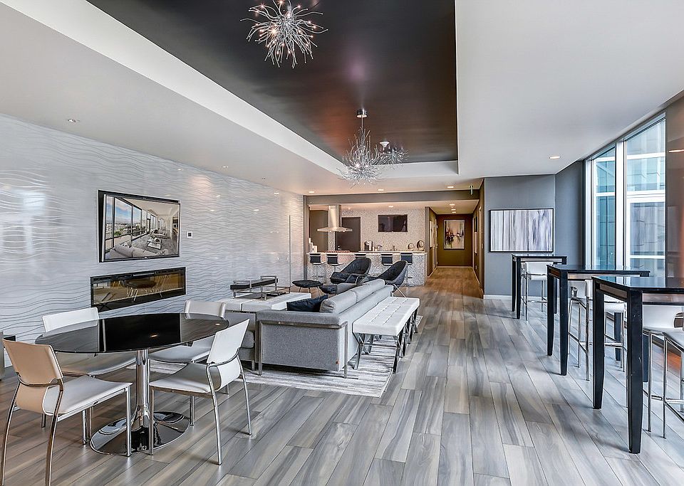 Club room with couch, table and chairs, TV and full kitchen.