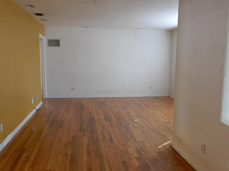 South view of house showing hardwood oak floors in living room and dining area.