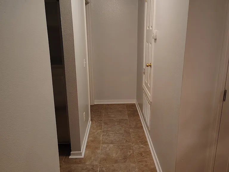 Hallway to Bedroom #1. (Kitchen to left; LR behind; Hallway to front door to right)