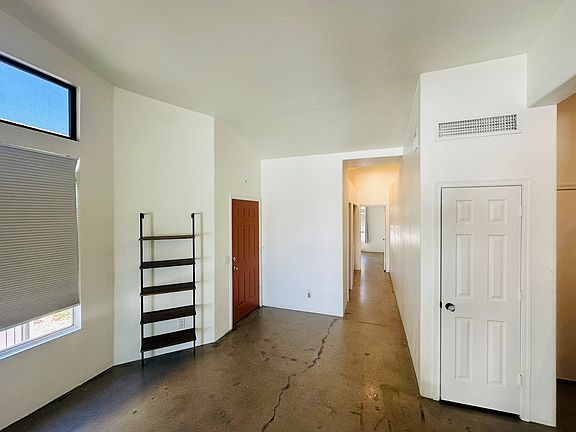 Front door, living room, living room closet, and hallway to the guest bedroom. Perfect floor plan with bedrooms on opposite sides of the home.