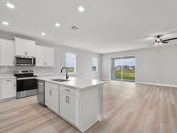 The kitchen overlooks the spacious living area.