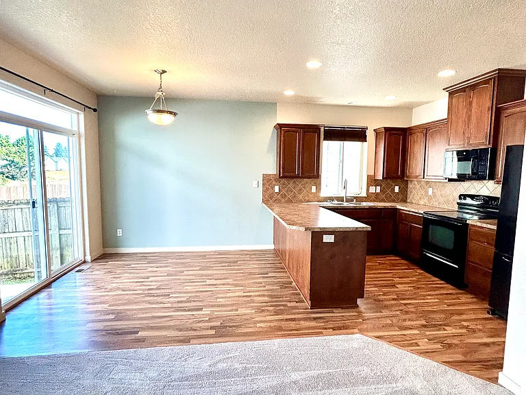 Kitchen & dining area with slider out to patio / yard