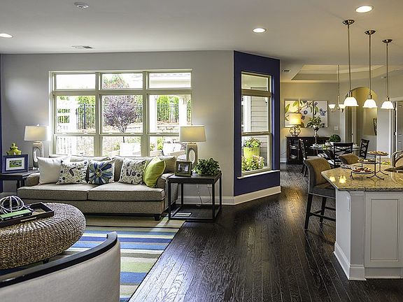 Interior photograph of a Portico living room, kitchen and dining room taken at Weddington.