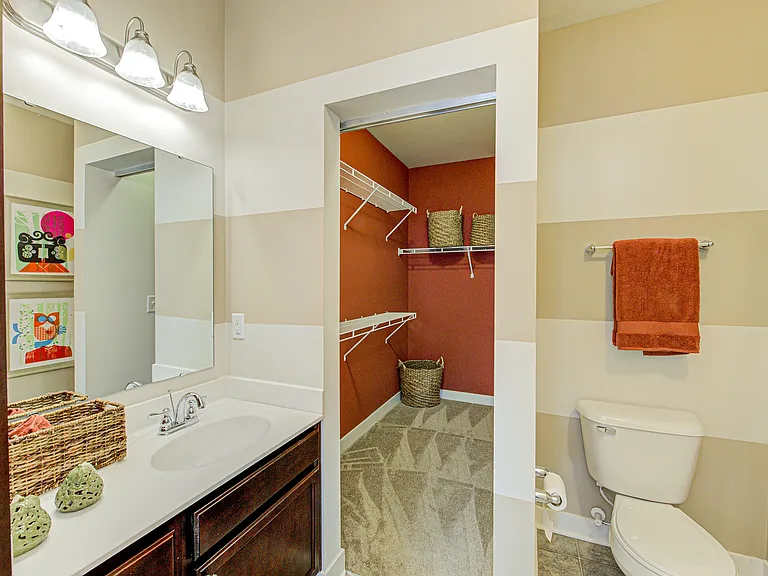 Plenty of storage meets everyday convenience _ this bathroom flows right into a spacious walk-in closet to keep your routine stress-free.