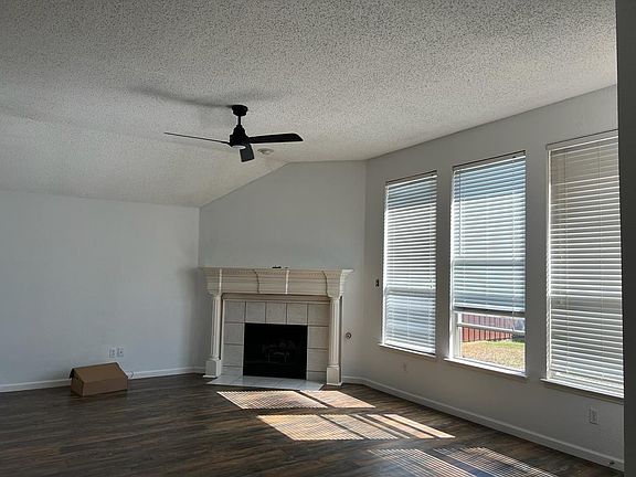 Living room with hardwood floors and ceiling fan