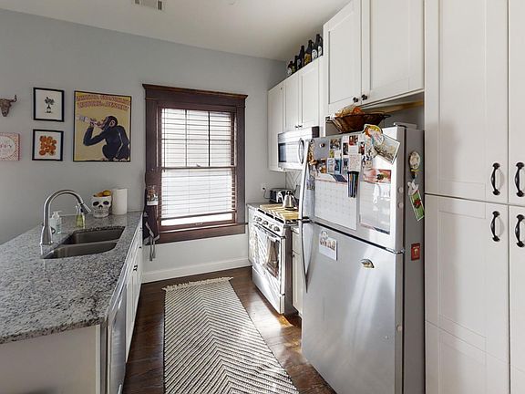 Remodeled kitchen with bar seating, newer appliances, and pantry