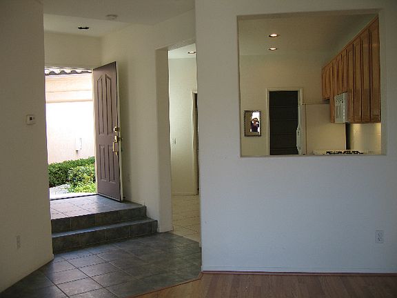 Front door and entry with view to kitchen
