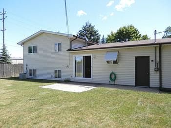 Spacious back yard with cement patio