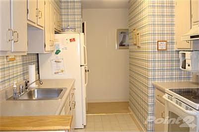 Efficient galley kitchen with spacious pantry.