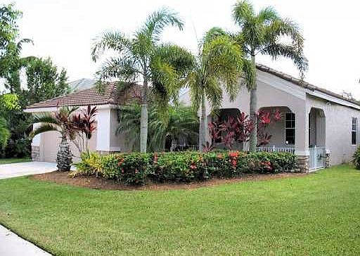 Home sits on a lushly landscaped, oversized corner lot