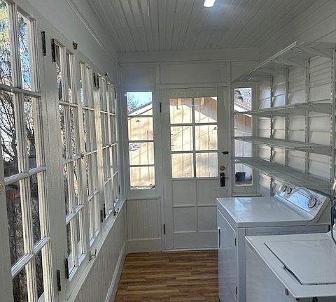 Updated laundry room with shelving and new flooring.