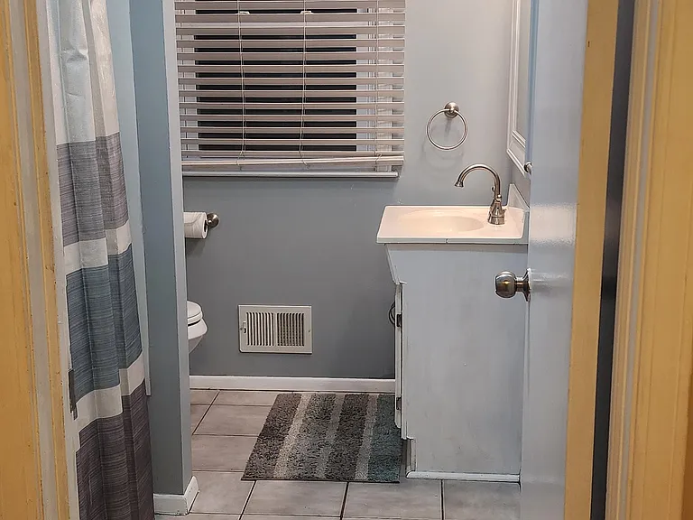 Bathroom with vanity lights and fan. Full shower/tub