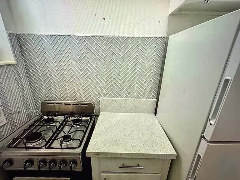 gas stove, refrigerator and work area - really well designed kitchen triangle