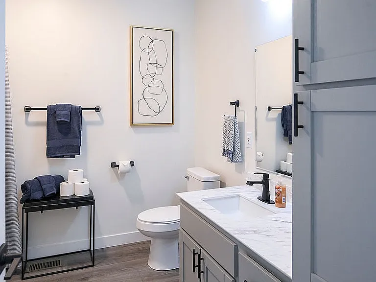 Contemporary bathroom with elegant marble countertop, modern fixtures, and stylish decor creating a luxurious ambiance.