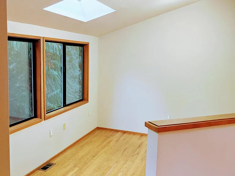 Skylight and multiple ceiling lights provide plentiful lighting to the office.