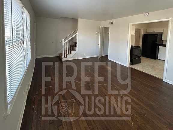 Living Room looking toward Kitchen, and coat closet near entry.