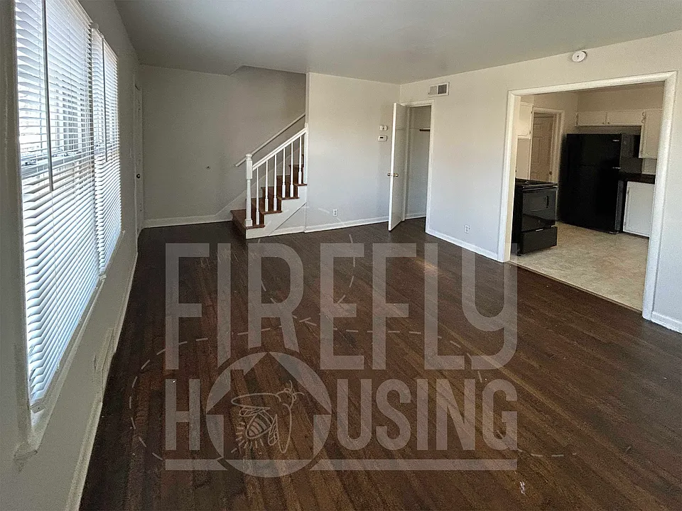 Living Room looking toward Kitchen, and coat closet near entry.