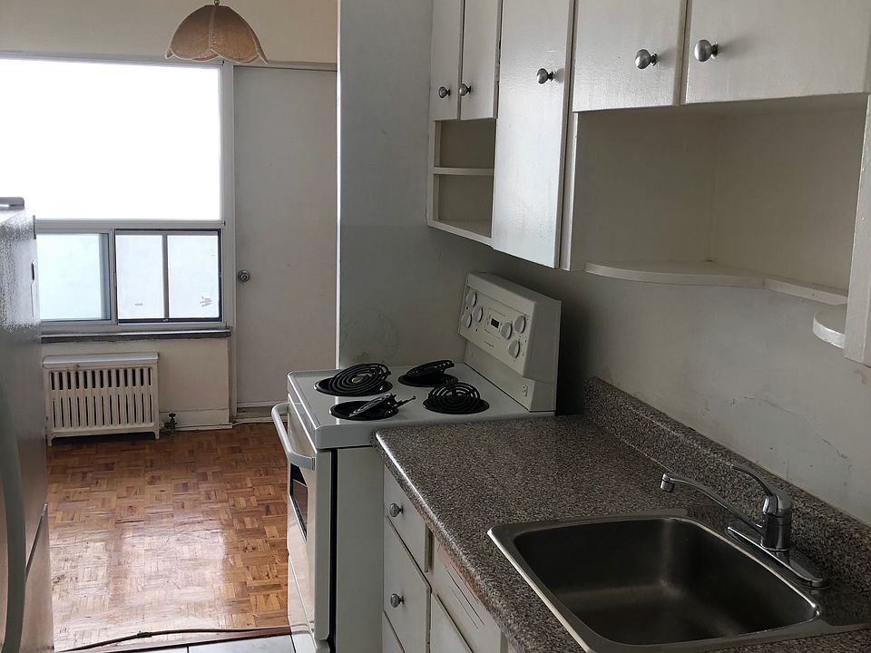 Kitchen looking into dining area and balcony