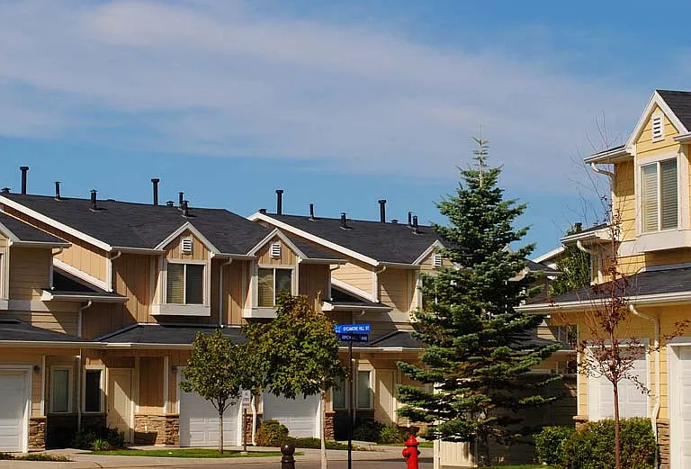 Liberty Hill Apartments, Draper, Utah, a row of yellow townhomes with white garage doors and black roofs.