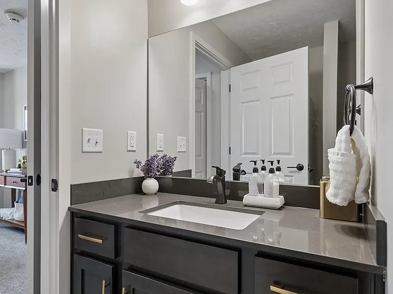 Elegant cabinetry, contemporary fixtures, and a spacious vanity create a bathroom that feels both refined and functional.