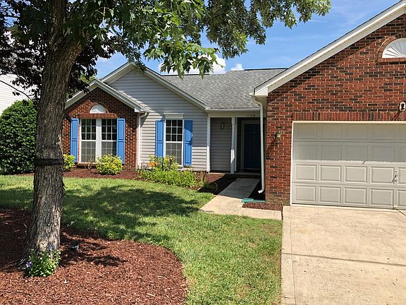 Professional landscaping with mature trees and private patio