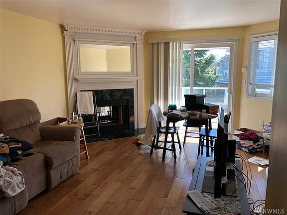 Large living room with corner fireplace. Craftsman over-mantle looks great.