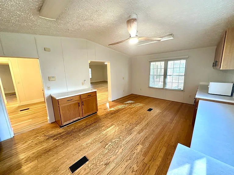 View from the kitchen into the mud room (left) and the living area (right)