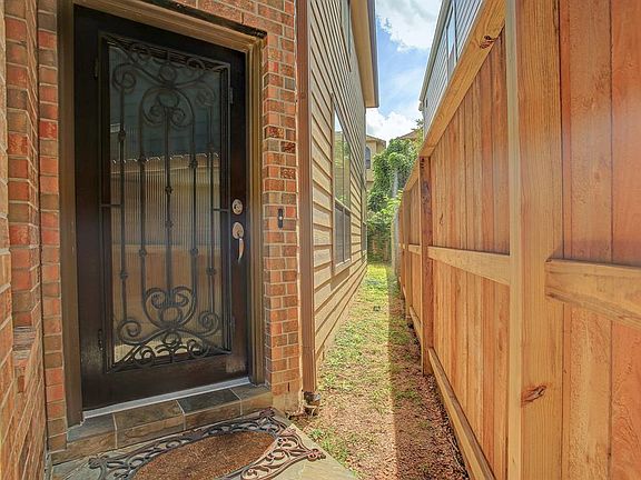 Beautiful wood, glass & wrought iron door and slate porch greet you upon arrival