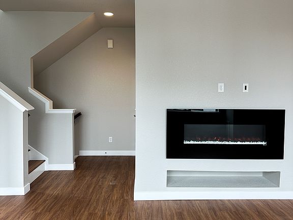 Electrical Fireplace & open hall / stairway connecting to each level